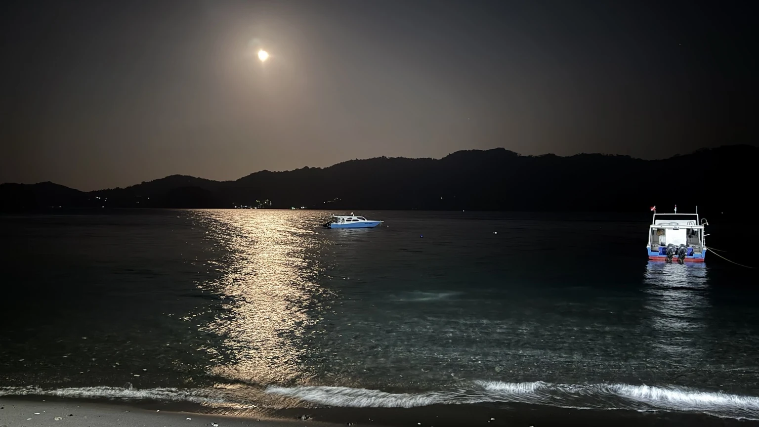 Moonrise over the Lembeh Strait with Dive Into Lembeh dive boats at night